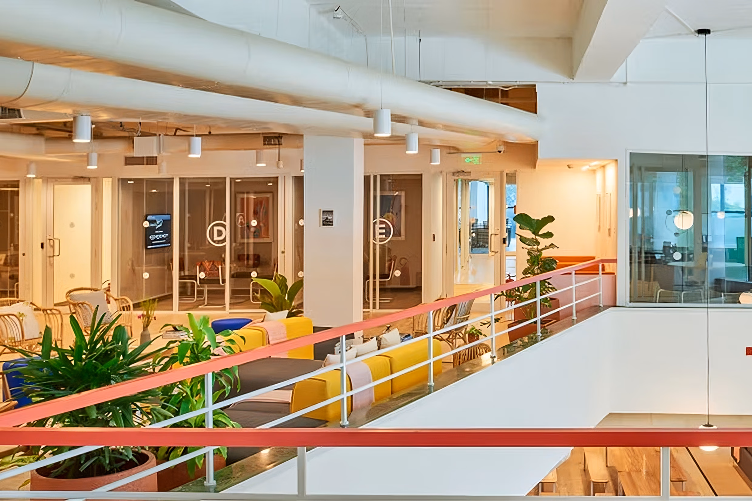 Modern office interior with glass meeting rooms and indoor plants